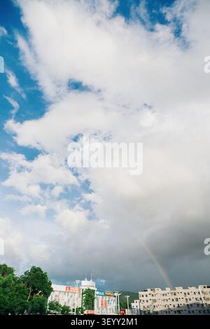 Rainbow over urban skyline in Chengdu, Sichuan, China — dramatic clouds, modern buildings, and Stock Photo