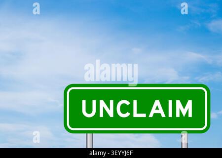 Green color transportation sign with word unclaim on blue sky with white cloud background Stock Photo