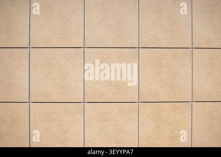 Beige square ceramic tile wall texture background Stock Photo
