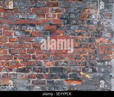 Dark grungy weathered red and black brick wall texture Stock Photo