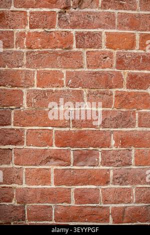 Aged red brick wall texture vertical pattern background Stock Photo
