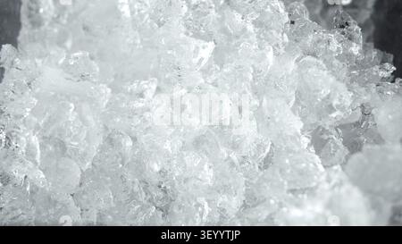 Crushed ice forming a detailed texture, showing sharp crystal fragments and cold frosty surfaces Stock Photo