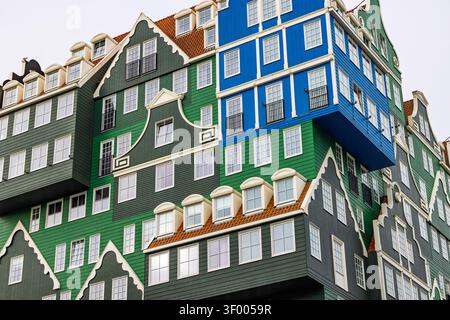 Zaandam, Netherlands. Low angle architectural view of the iconic stacked traditional green and blue wooden houses forming a unique hotel facade. Stock Photo