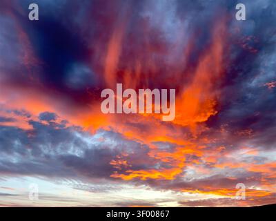 Vibrant orange & blue sky with clouds during sunset Stock Photo