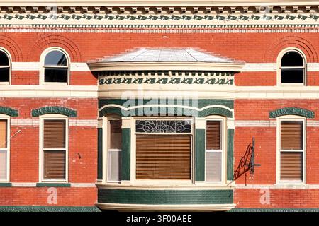 Galena, Illinois, USA - May 30, 2026: Close-up of ornate historic brick building facade featuring decorative masonry, arched windows, and a bay window Stock Photo