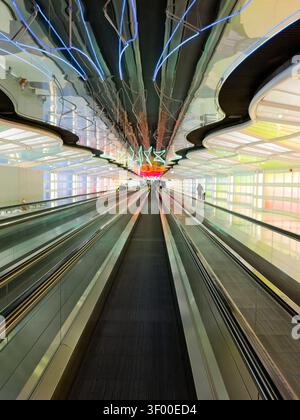 CHICAGO, IL, USA - JANUARY 20, 2026: Illuminated neon light tunnel at O'Hare International Airport. The neon light tunnel is a well-known installation Stock Photo