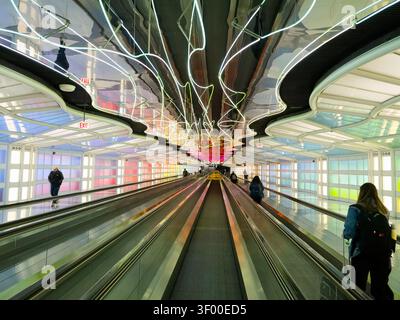 CHICAGO, IL, USA - JANUARY 20, 2026: Colorful illuminated walkway in Chicago O'Hare International Airport terminal. This is the iconic pedestrian walk Stock Photo