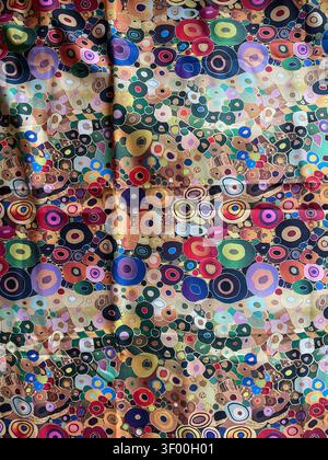Vibrant concentric circles in rich earth tones and indigo create a dynamic, playful pattern on this beautiful Japanese fabric Stock Photo