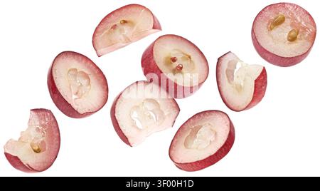 Falling red grape slices isolated on white background Stock Photo
