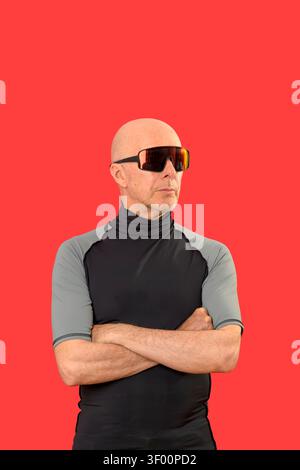 sporty bald man standing with arms folded Stock Photo