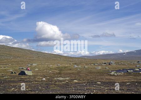 Barren hilly landscape under bright blue sky with scattered clouds, Fjell, Valdesflye, Gjendersheim, Jotunheimen, Norway Stock Photo