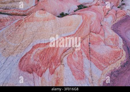 Abstract aerial view of colorful sandstone waves and cracked textures in White Pocket at Coyote Buttes North, Utah, USA, a remote desert landscape wit Stock Photo