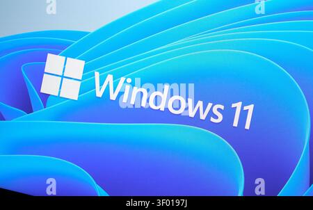 CHICAGO, IL, USA - JULY 15, 2021: An image of the Windows 11 logo displayed against a blue wavy abstract background. This visual promotes the operatin Stock Photo