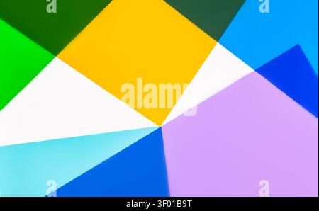 Vibrant abstract geometric background with overlapping paper-like triangles in yellow, green, blue, cyan, white, and purple, creating a modern minimal Stock Photo