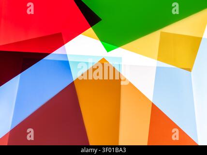 Vibrant abstract composition of overlapping translucent geometric shapes in red, green, yellow, blue, and orange, creating a modern background with bo Stock Photo