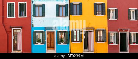 Burano Venice colorful houses facades panorama with traditional windows and wooden shutters Italy bright red blue yellow wall art background decorativ Stock Photo