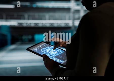 Computer scientist works with a computer workstation in a server hub to support artificial intelligence systems. Stock Photo