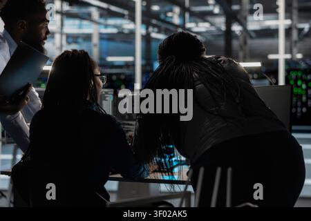 Data center engineering team deploy data backup solutions, managing server storage and supporting reliable recovery. Stock Photo
