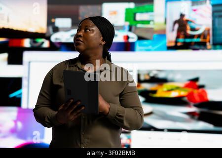 Woman works with digital tablet to receive custom video suggestions delivered instantly. VOD platform user enjoying unlimited streaming opportunities in digital era, working with device. Stock Photo