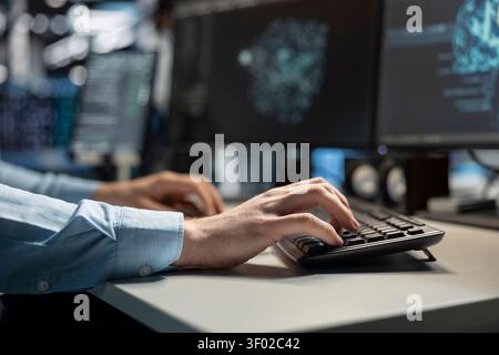 Data center technician uses a desktop computer in a data center to deploy software updates, configure hardware, and support reliable operations. Stock Photo