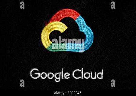 DALLAS, TX, USA - FEBRUARY 16, 2024: A detailed view of the Google Cloud logo, displaying its distinctive multicolored design on a black fabric backdr Stock Photo