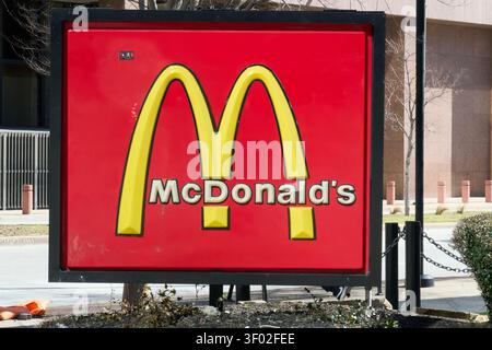 DALLAS, TX, USA - FEBRUARY 16, 2024: The photograph features a prominent McDonald's sign displaying the iconic golden arches and company name on a bri Stock Photo