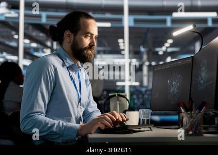 Software developer reviews artificial intelligence systems and machine learning processes inside a data center. Stock Photo