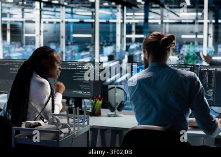 Data center team works together on diagnostics, maintenance tasks and server equipment performance checks. Stock Photo