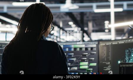 System administrator reviews node tree software to analyze datasets and improve server infrastructure performance. Stock Photo