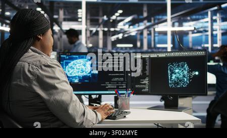 Server facility staff member rolling out AI solutions optimizing equipment. Server environment software engineer applying AI technology minimizing infrastructure downtime. Stock Photo