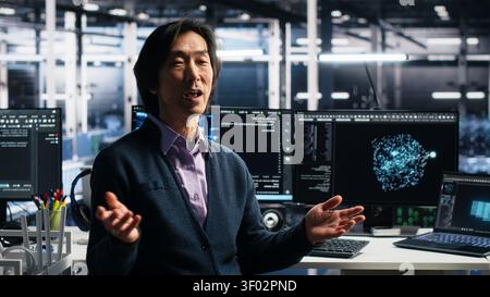 Smiling server room manager filming presentation, showcasing equipment working with AI tech. Stock Photo