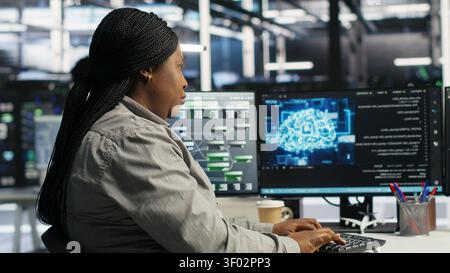 Server facility staff member rolling out AI solutions optimizing equipment. Server environment software engineer applying AI technology minimizing infrastructure downtime. Stock Photo