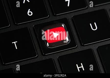 DALLAS, TX, USA - FEBRUARY 16, 2024: A close-up image of a keyboard featuring a unique key with the YouTube logo in place of a standard key. The keybo Stock Photo