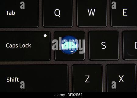 DALLAS, TX, USA - FEBRUARY 16, 2024: A close-up image showing a black keyboard with a special key featuring the Android logo. The design replaces a st Stock Photo