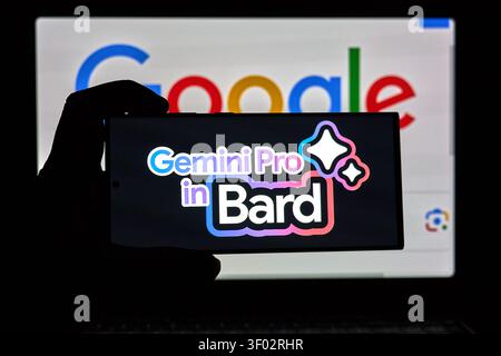DALLAS, TX, USA - FEBRUARY 16, 2024: A silhouette of a hand is seen holding a smartphone which displays the text 'Gemini Pro in Bard' prominently on i Stock Photo