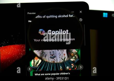 CARROLLTON, TX, USA - FEBRUARY 24, 2024: A digital screen displays the Copilot logo and slogan 'Your everyday AI companion', highlighted by a magnifyi Stock Photo
