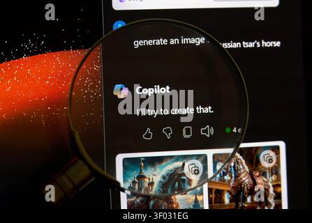 CARROLLTON, TX, USA - FEBRUARY 24, 2024: Magnifying glass highlights a screen displaying Copilot AI interface featuring the logo and response text. Sc Stock Photo