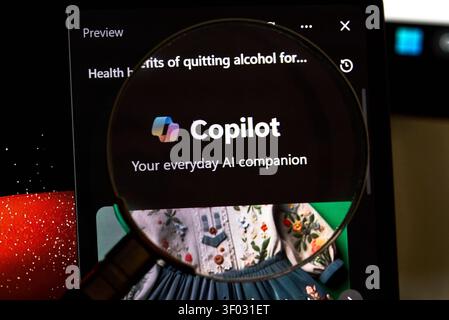 CARROLLTON, TX, USA - FEBRUARY 24, 2024: A magnifying glass reveals the Copilot application interface, showcasing its logo and assurance as 'Your ever Stock Photo