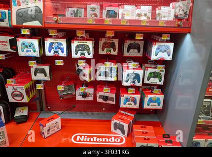 CARROLLTON, TX, USA - FEBRUARY 24, 2024: A store display showcases a variety of Nintendo Switch controllers featuring popular themes like Mario, Splat Stock Photo
