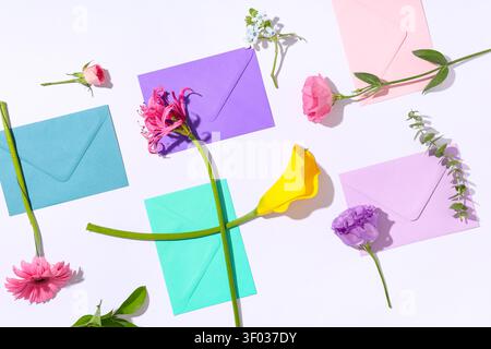 Composition with different envelopes and flowers on white background, closeup Stock Photo