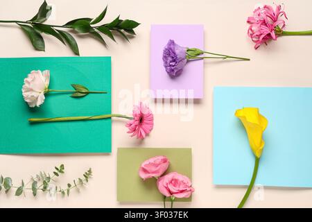 Composition with envelopes and different flowers on beige background Stock Photo