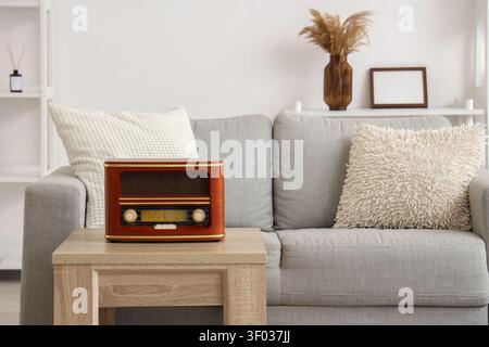 Vintage radio on wooden table in modern living room Stock Photo