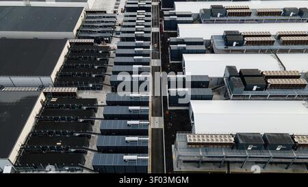 Aerial view of a large data center facility featuring rows of server containers and industrial cooling systems in Keflavik, Reykjanesbaer, Iceland. Stock Photo
