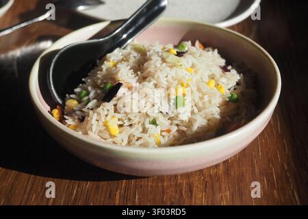Steamed rice with vegetables served in a bowl Stock Photo