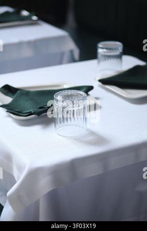 Table set for dining in a restaurant at evening time Stock Photo
