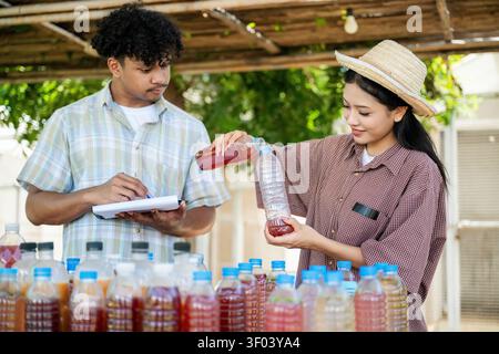 Agricultural students produce organic fertilizers, natural gardener compost tea prepared for agriculture with documenting biofertilizer production Stock Photo