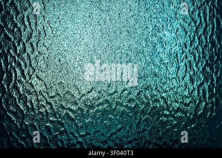 Teal frosted glass texture with translucent surface and soft light diffusion. Abstract background featuring subtle patterns and modern design aestheti Stock Photo