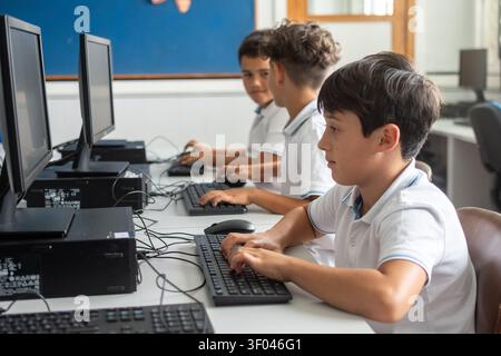Elementary School Boys Using Desktop Computers During an Information Technology Class Stock Photo