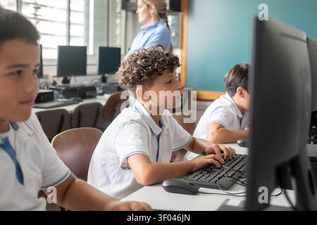 Elementary School Boys Using Desktop Computers During an Information Technology Class Stock Photo