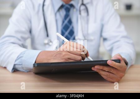 Healthcare Professional Using Digital Tablet for Medical Documen Stock Photo